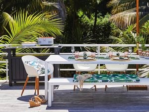 White outdoor setting under umbrella.