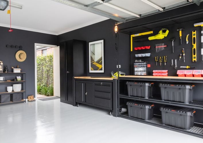 Garage featuring the Pinnacle Moduar storage range and various pegboard hooks.