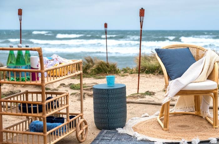 beach with rugs and torches