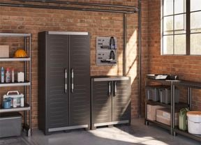 brick wall with shelving and black storage cabinets