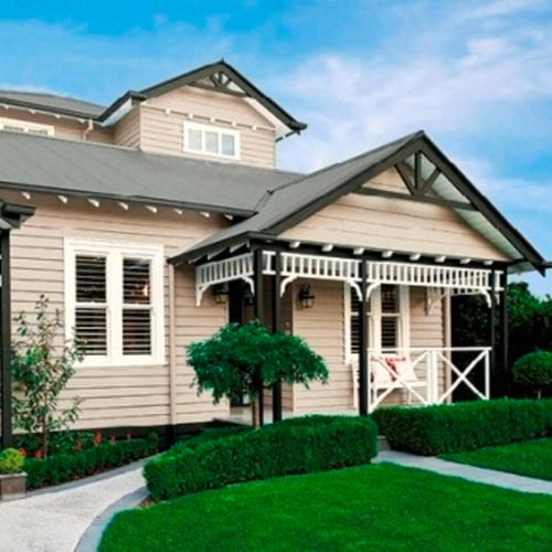 Weatherboard two storey house painted in woodland grey and summer beige in cabots timbercolour