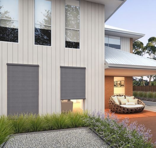 Exterior of a modern two-storey house showing external and internal blinds