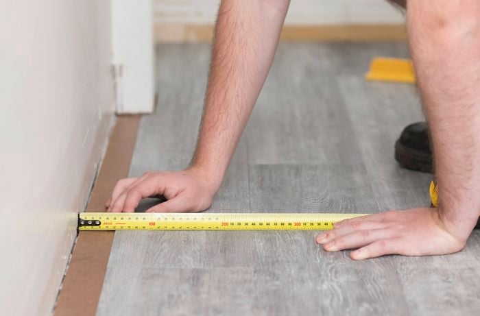 Measure the distance between the last full plank and the wall 