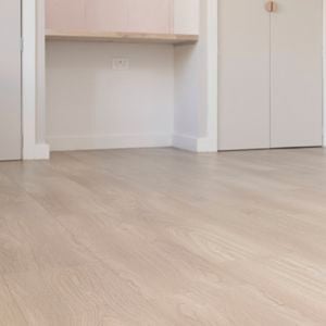 A room with new light laminate flooring 