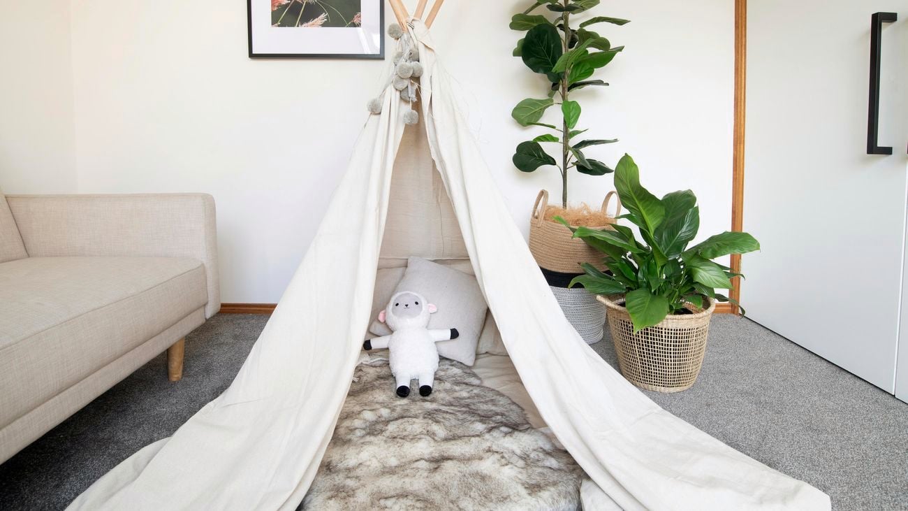 A child's indoor play tent set up in a living room.