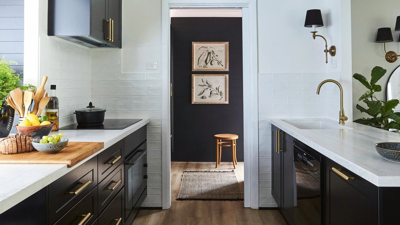 Monochrome kitchen with plenty of natural light and fruit and fresh bread on the benchtop