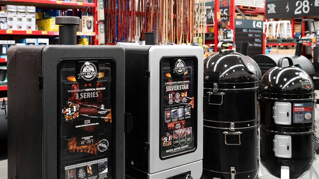 Pit Boss and Matador Catalyst vertical smokers displayed alongside other grilling accessories.