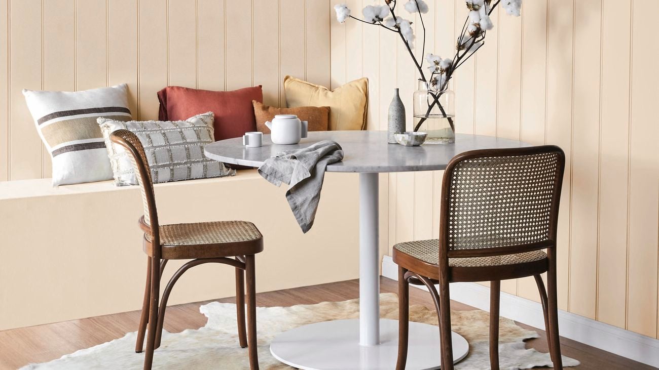 Country nook with table, chairs and cushions.