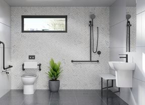 A white and grey toned bathroom fitted with assisted living products