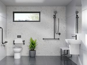 A white and grey toned bathroom fitted with assisted living products