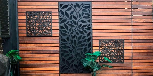 Outdoor decking area with timber panelled wall and mounted garden screens