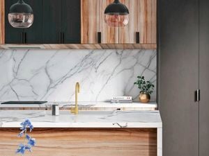 Close up of Kaboodle marble-look kitchen benchtop, sink and brushed brass sink mixer