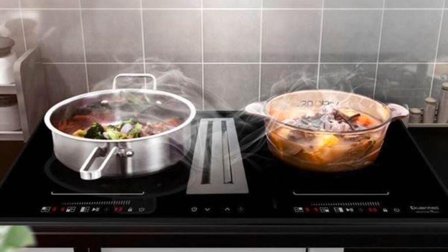 2 pots on Induction Cooktop with steam being drawn into Integrated Air Extraction System