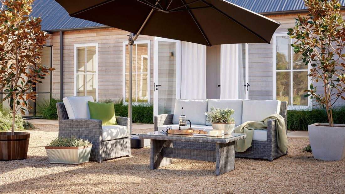 wicker outdoor setting in shot with umbrella