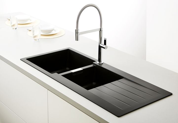 Kitchen benchtop with black sink and stainless steel tapware