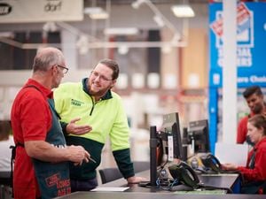 Bunnings team member helping a customer.