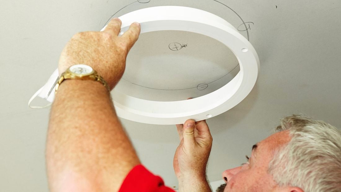 A skylight diffuser template being used to mark a hole in the ceiling to be cut to make way for Mylar tubing to come in from above