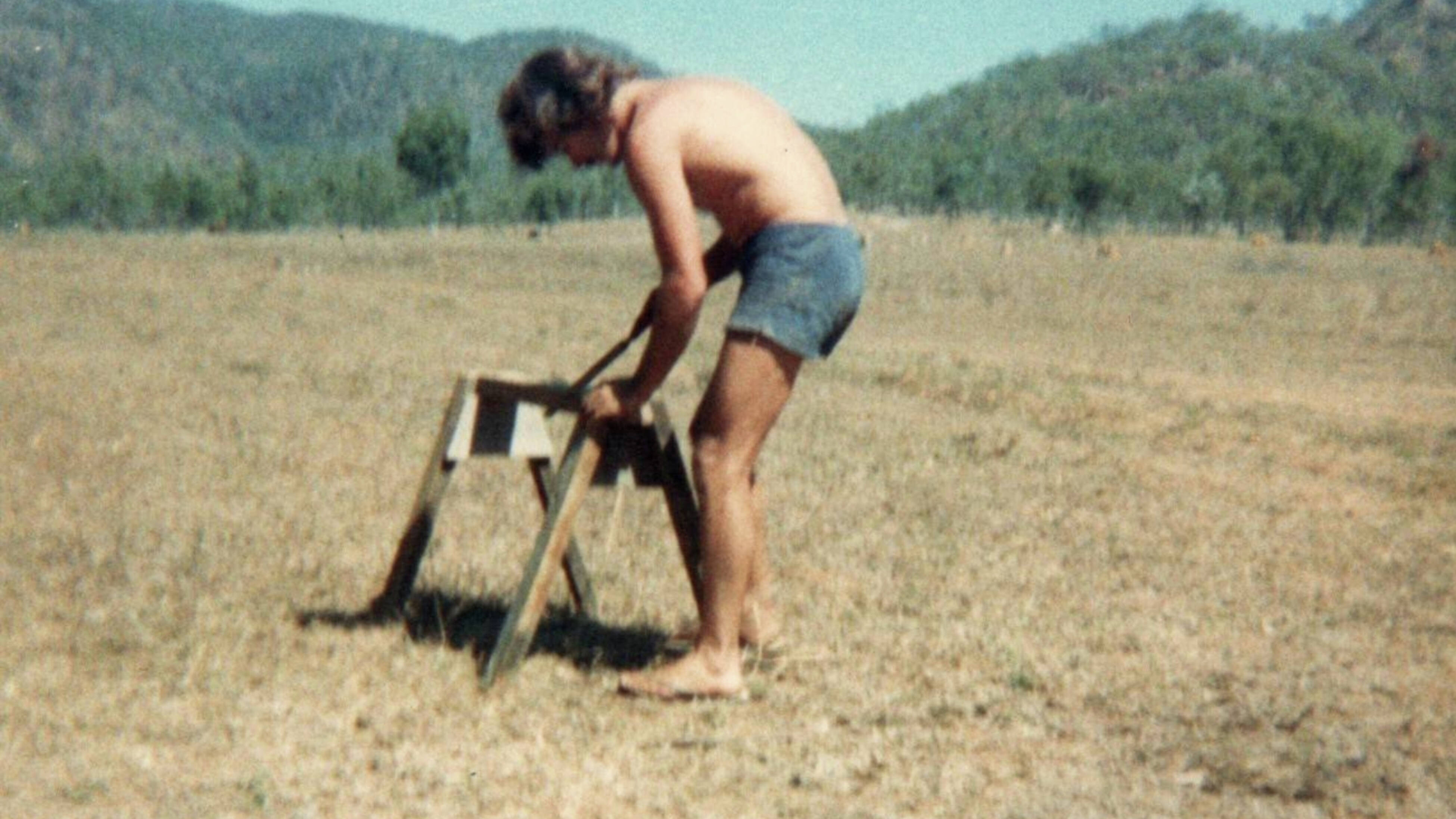 An image of MND sufferer Steve Simpson with a saw horse in a field