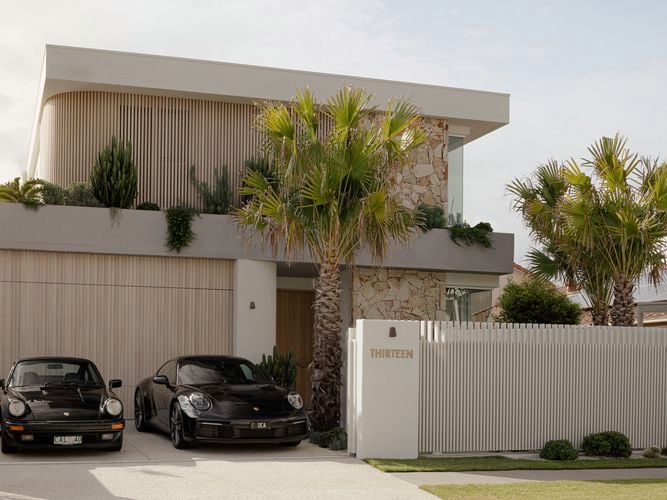 Modern house with birch coloured DECO installed to the facade of the house with luxury cars in the driveway