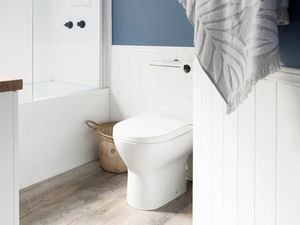 Hamptons style bathroom with bathtub and towels in shot