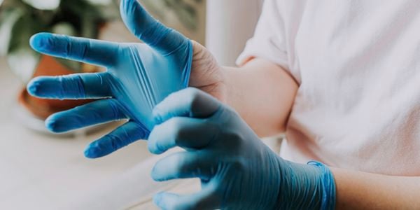 Man putting on gloves