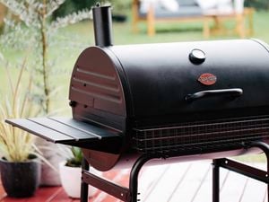 Barrel smoker on an outdoor deck