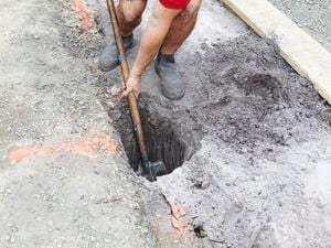 Person digging a post hole