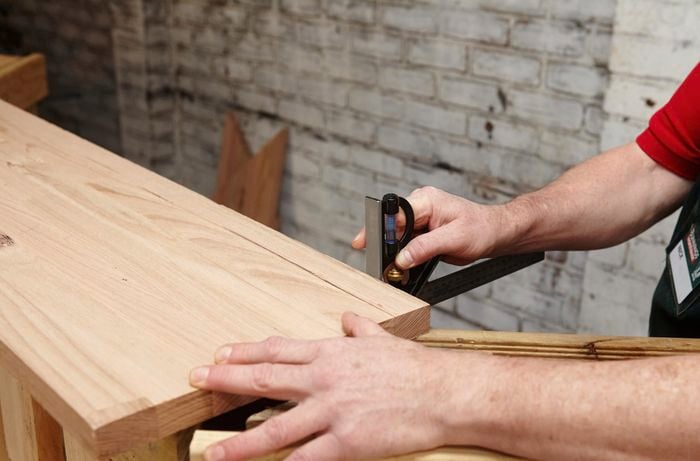 A square rule being used to position a wine bar counter onto a wooden pallet frame