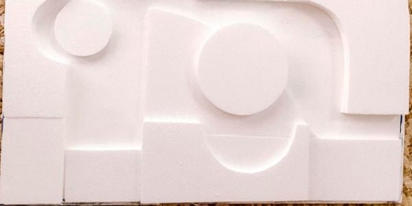 Applying foam shapes to art canvas