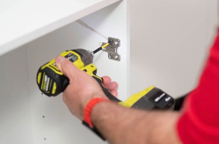 Fit the hinges inside the cabinet 