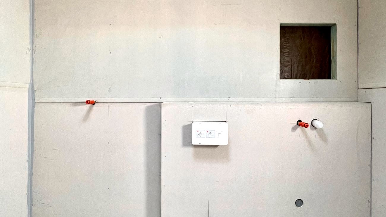 A blank bathroom under renovation with fixtures being placed into walls before waterproofing.