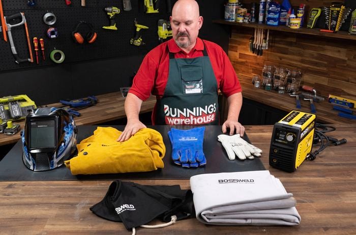 Bunnings team member standing in front of safety equipment.