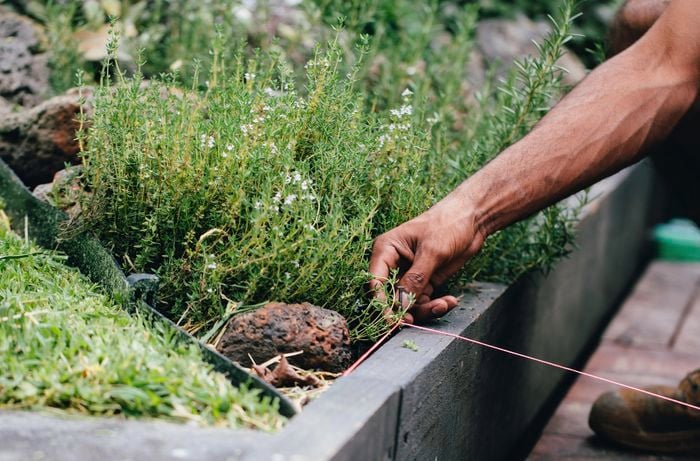 String being used to measure the width of a retaining wall