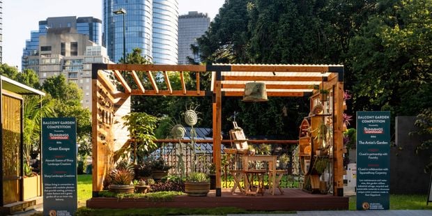 Two balcony garden competition with a garden set up with plants in pots, timber shelving and rustic decor.