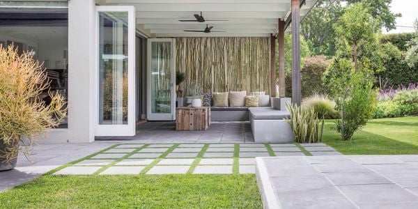 Backyard with pavers and outdoor setting.