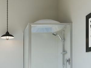 Modern white bathroom with black pendant lights and white tiled floor.