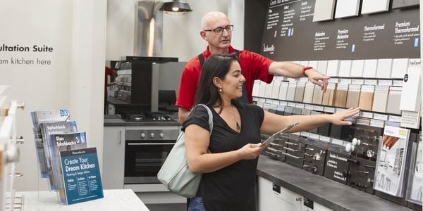 Bunnings team member helping customer.