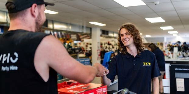 TKD team member and customer paying for Milwaukee tools