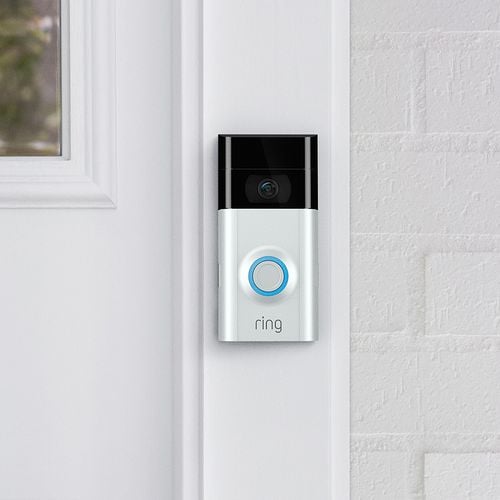 Press button doorbell mounted next to a front door