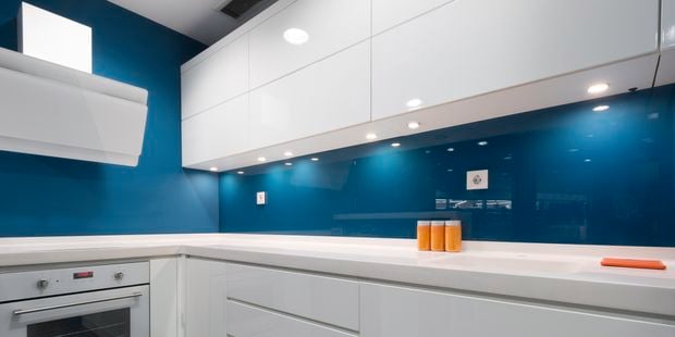 Kitchen with blue splashback.