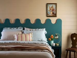 Wavy headboard in blue behind a bed for effect 
