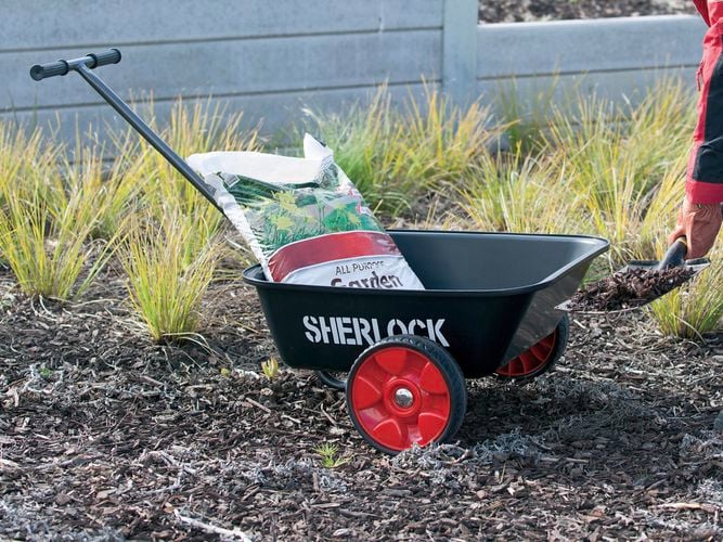 Person carting all pupose garden mulch