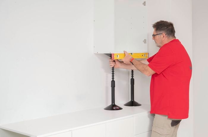 Position the cabinet using a cabinet stand and a level 