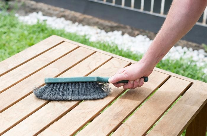 Brush wiping down timber table