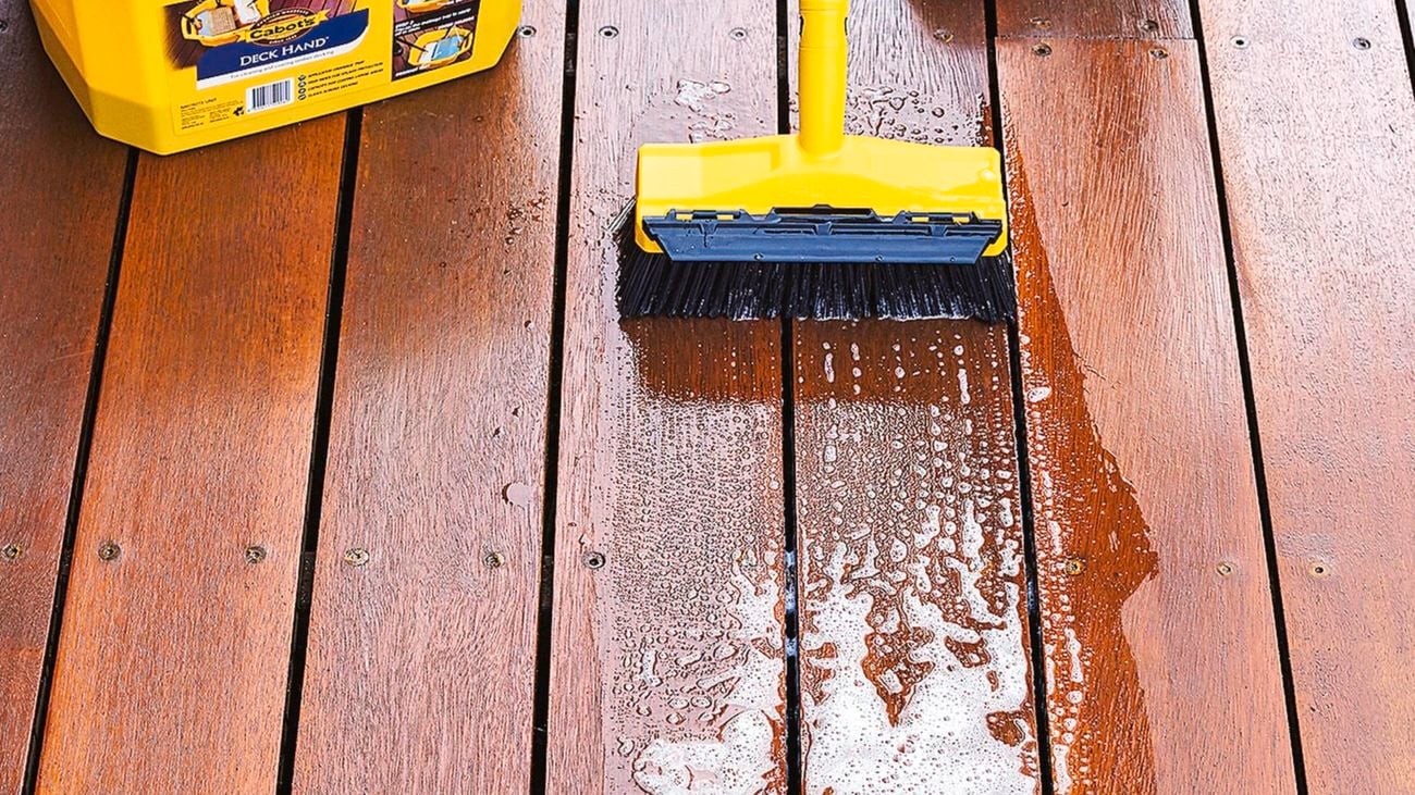 Outdoor deck being scrubbed with Cabot's Deck Hand product.