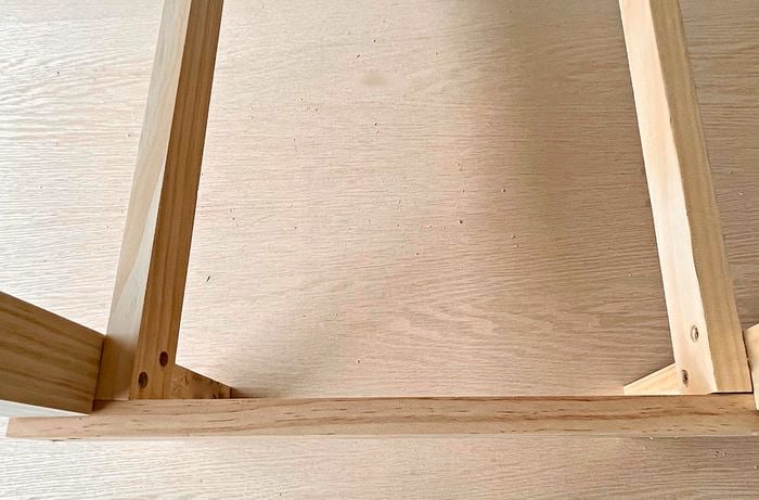 Frame of a kitchen trolley secured with screws.
