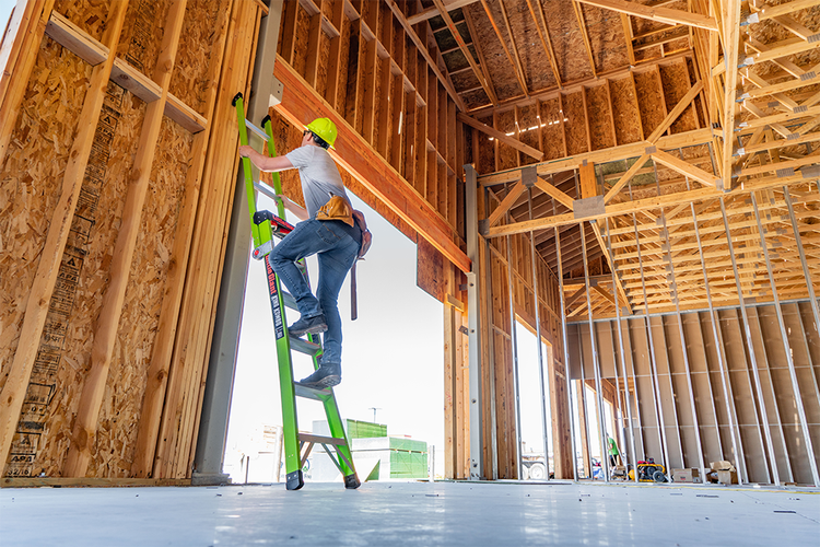 Person climbing ladder on a worksite