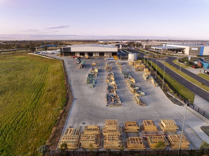 Birds eye view of Bunnings Frame and Truss building with timber stacked inthe back ground