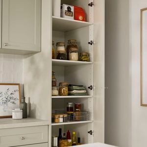 Open kitchen pantry cupboard in pistachio kitchen