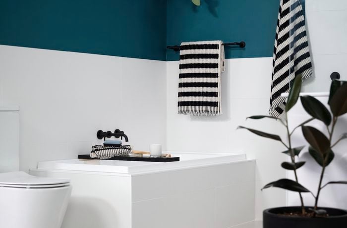 Bathroom with jade and white colour and black fittings. 